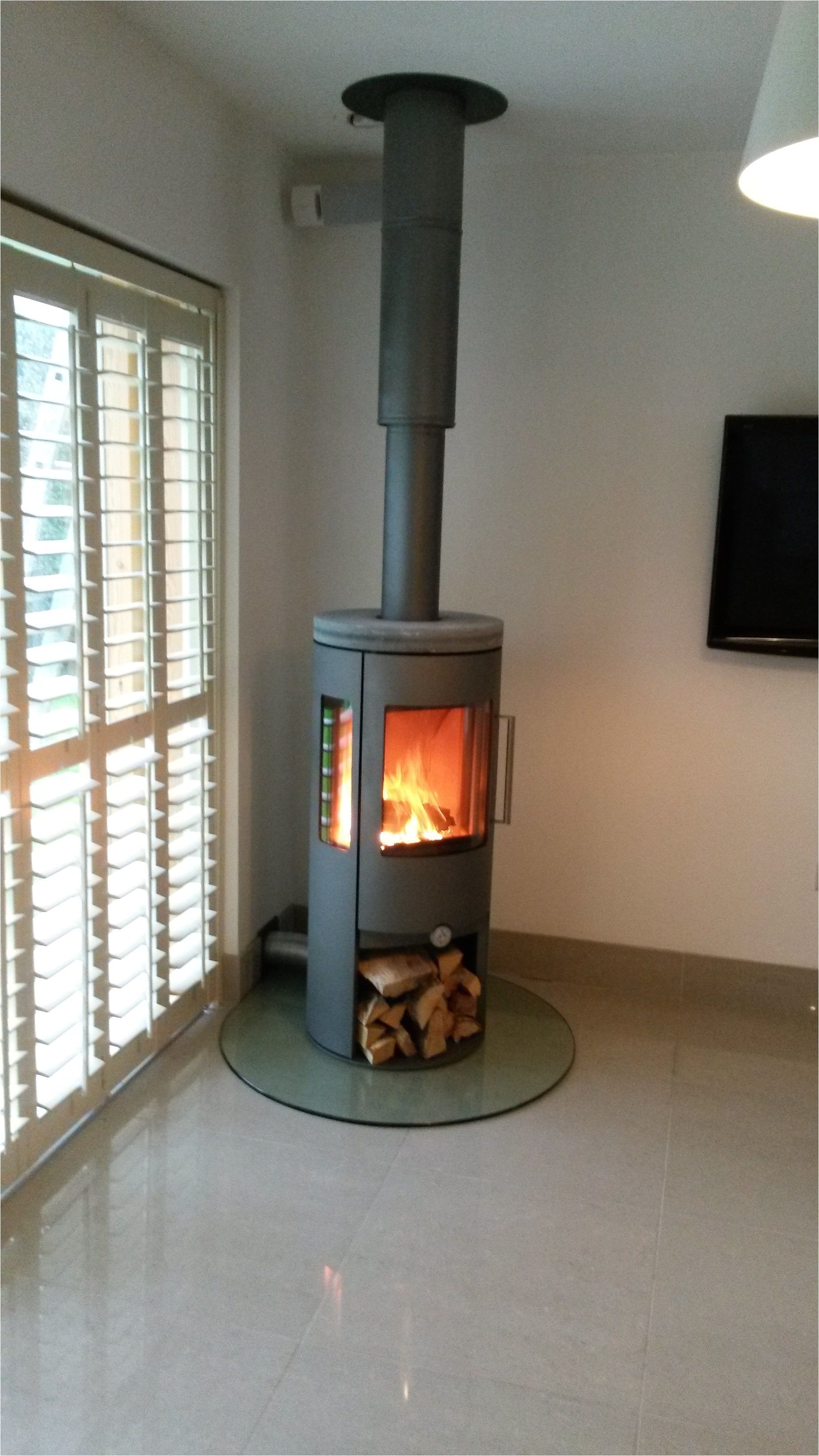 dan skan nuro 120 with side glass log store and soapstone top plate plate glass hearth